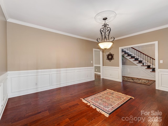 empty room with ornamental molding and dark wood-type flooring