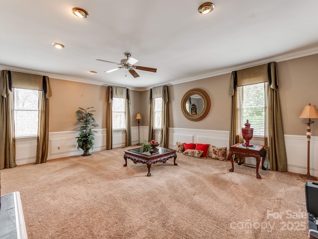 living room with ornamental molding, plenty of natural light, and light carpet