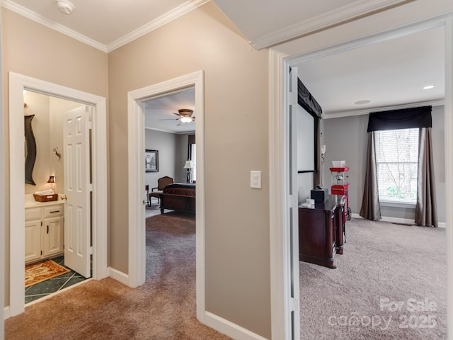 corridor featuring ornamental molding and light carpet