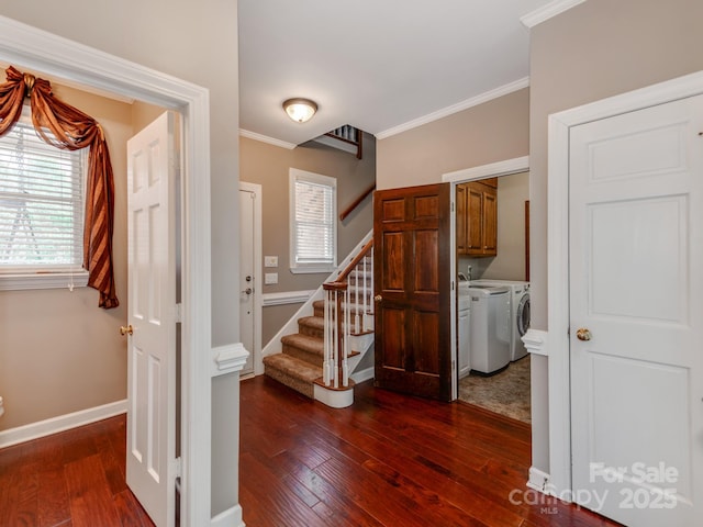 entrance foyer featuring crown molding, dark hardwood / wood-style flooring, and washer and dryer