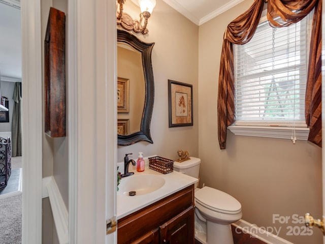 bathroom featuring vanity, ornamental molding, and toilet