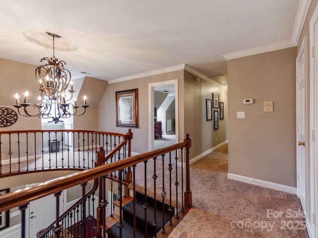 hall with ornamental molding, carpet floors, and an inviting chandelier