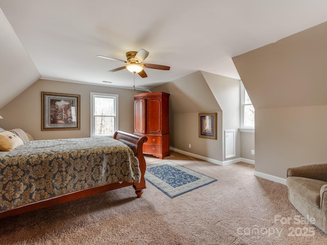 bedroom featuring multiple windows, lofted ceiling, light colored carpet, and ceiling fan