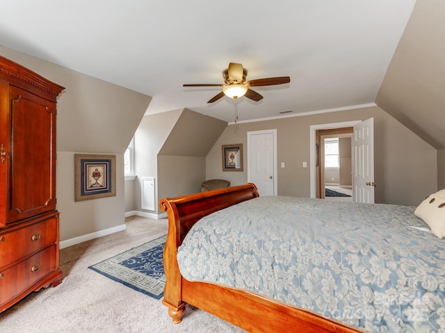 bedroom with vaulted ceiling, light colored carpet, and ceiling fan