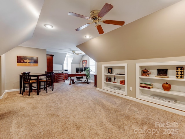 playroom with vaulted ceiling, ceiling fan, carpet floors, and built in features