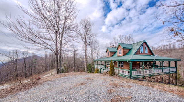 view of property exterior featuring covered porch