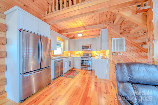 kitchen with sink, wood ceiling, stainless steel appliances, beamed ceiling, and light wood-type flooring