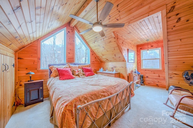 carpeted bedroom featuring multiple windows, wood ceiling, and wooden walls