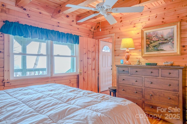 bedroom with vaulted ceiling with beams, wooden walls, and wooden ceiling