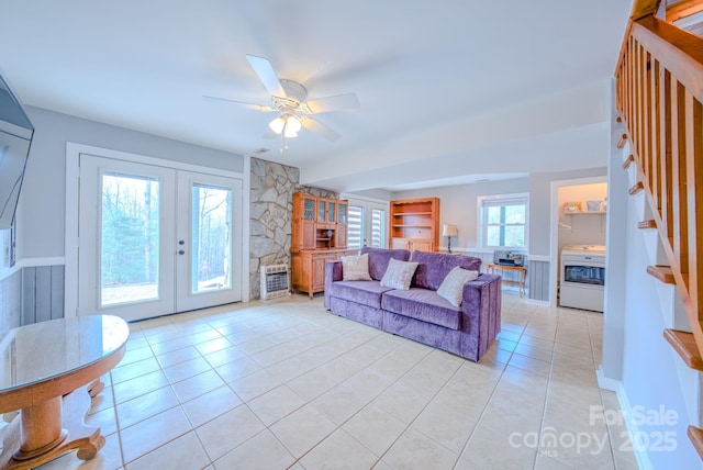 living room featuring light tile patterned floors, french doors, and ceiling fan