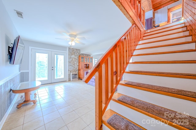 entryway with light tile patterned flooring, ceiling fan, and french doors