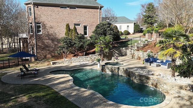 view of pool featuring a pool with connected hot tub, outdoor lounge area, a patio, and fence