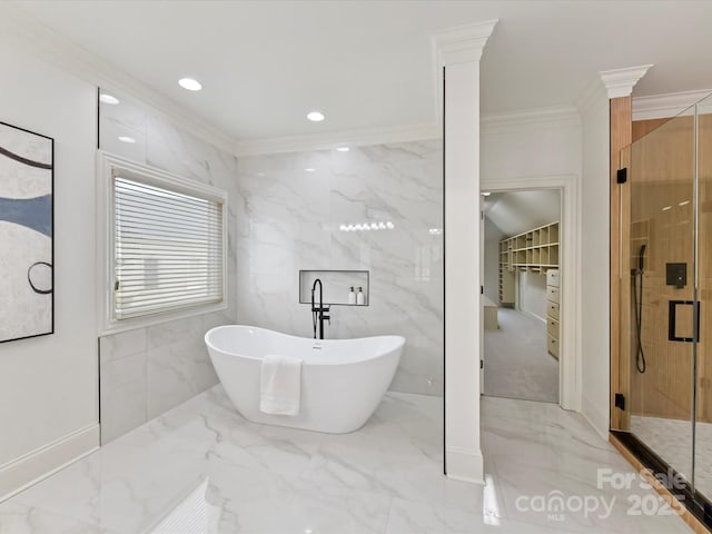 bathroom featuring marble finish floor, a stall shower, a freestanding bath, and crown molding