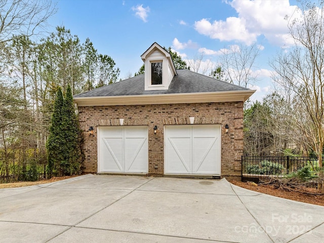 garage with a garage and fence