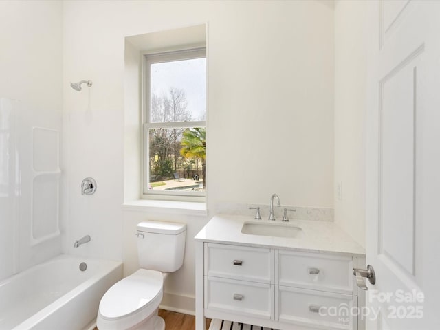 bathroom with toilet, shower / washtub combination, and vanity