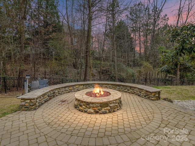 view of patio with fence and an outdoor fire pit