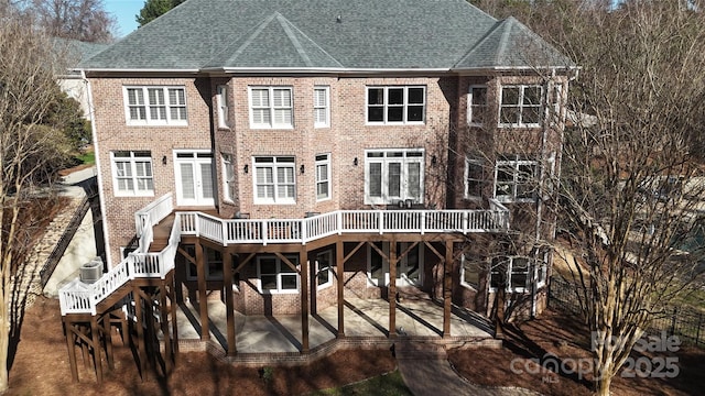 rear view of property featuring a patio area and brick siding