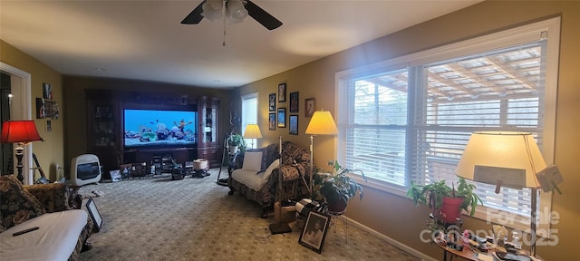 living room featuring ceiling fan, a healthy amount of sunlight, and carpet flooring