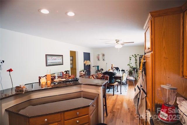 25 Upland Rd, Brevard, NC 28712 - kitchen with brown cabinets, a ceiling fan, light wood-style floors, dark stone counters, and recessed lighting