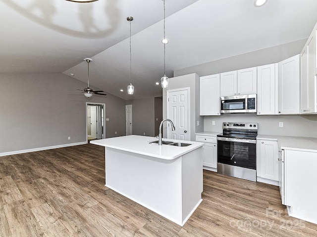 kitchen featuring white cabinetry, stainless steel appliances, sink, and a center island with sink