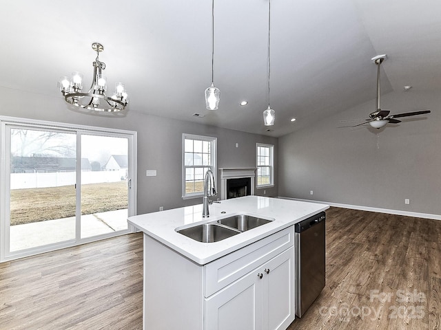 kitchen with sink, dishwasher, an island with sink, pendant lighting, and white cabinets