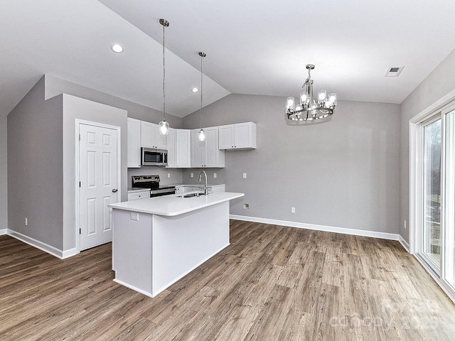 kitchen featuring sink, white cabinetry, a center island with sink, pendant lighting, and stainless steel appliances