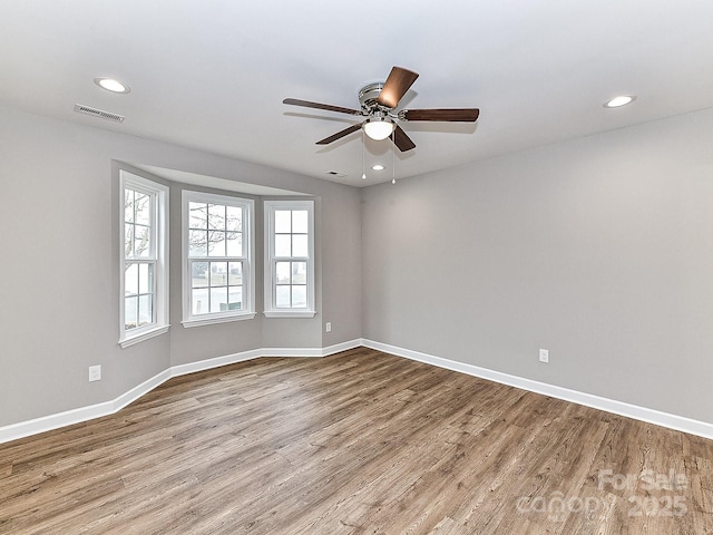 spare room featuring ceiling fan and light wood-type flooring