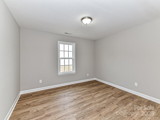 unfurnished room featuring wood-type flooring