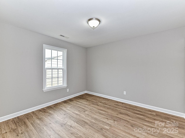 unfurnished room featuring wood-type flooring