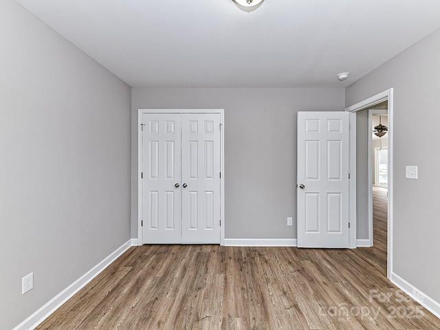 unfurnished bedroom featuring hardwood / wood-style flooring and a closet