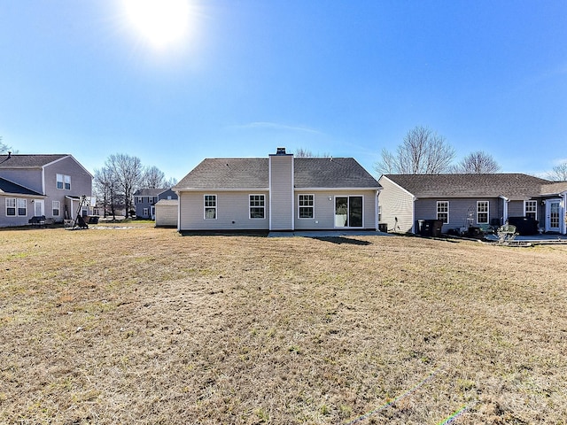 rear view of property with a yard