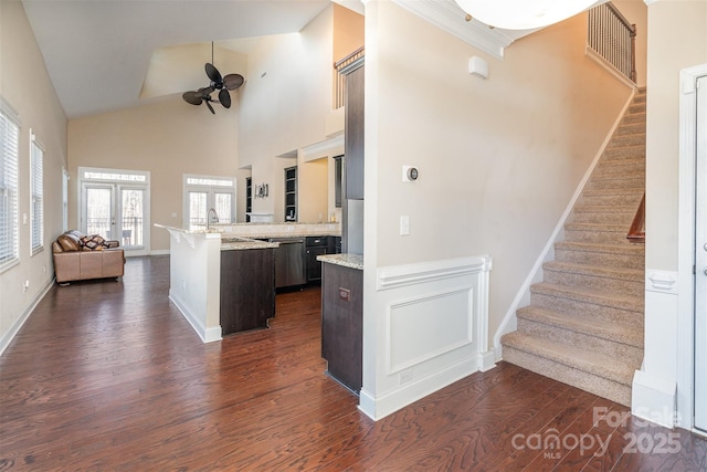 kitchen featuring french doors, dark wood-type flooring, a center island, high vaulted ceiling, and dark brown cabinets