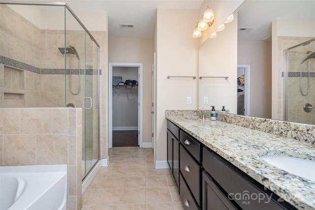 bathroom with vanity, tile patterned floors, and shower with separate bathtub