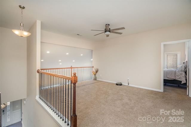 carpeted spare room with ceiling fan