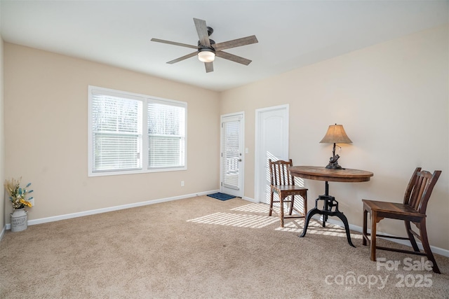 sitting room featuring light carpet and ceiling fan