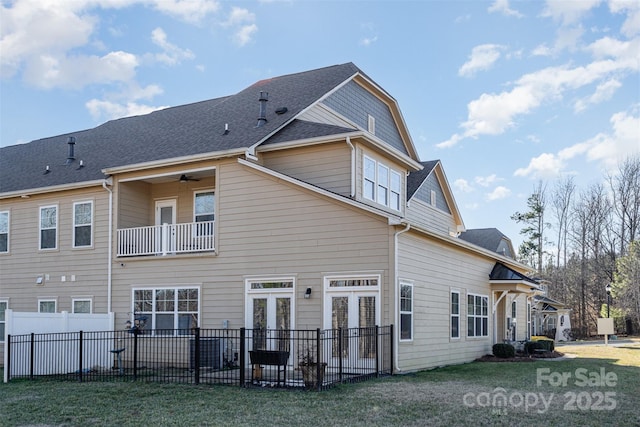 rear view of property featuring french doors and a balcony