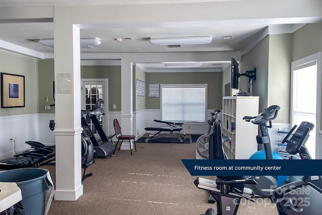 gym featuring ornate columns