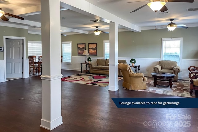 living room featuring ornate columns, dark hardwood / wood-style flooring, and beam ceiling