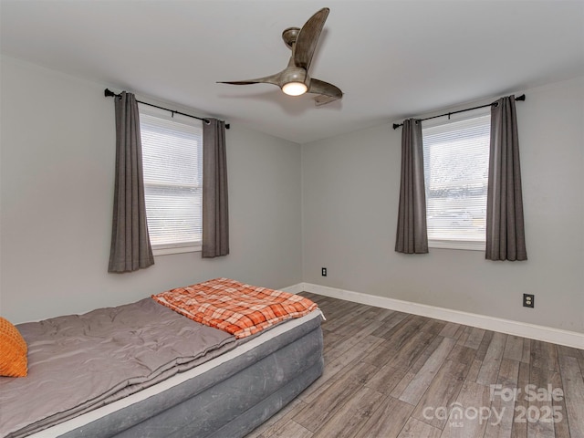 bedroom featuring hardwood / wood-style floors and ceiling fan