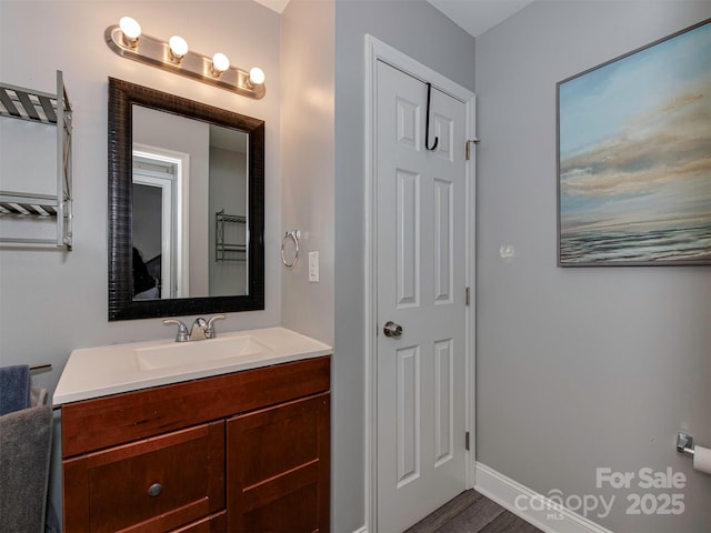 bathroom featuring baseboards and vanity