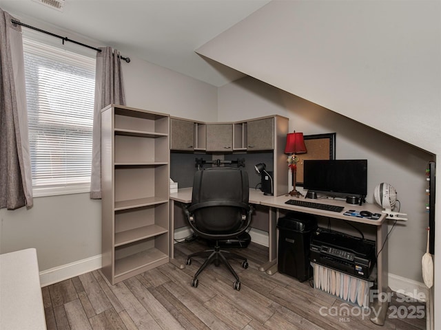 office with light wood-style flooring and baseboards