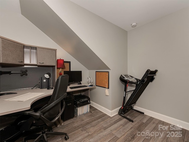 office with wood-type flooring and lofted ceiling