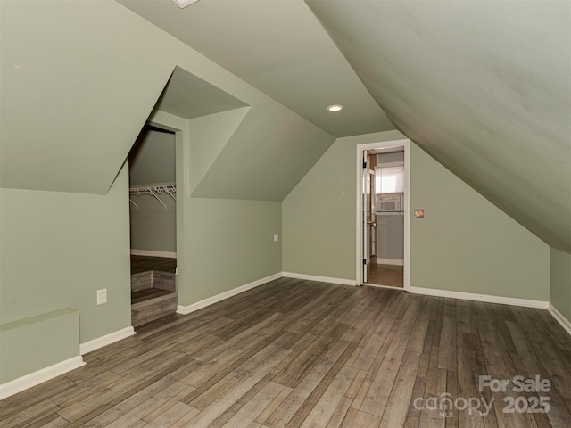 bonus room featuring lofted ceiling, wood finished floors, and baseboards