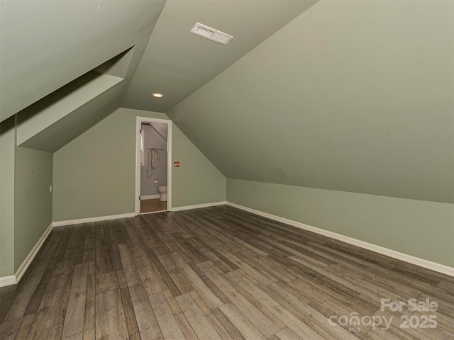 bonus room with lofted ceiling, baseboards, visible vents, and wood finished floors