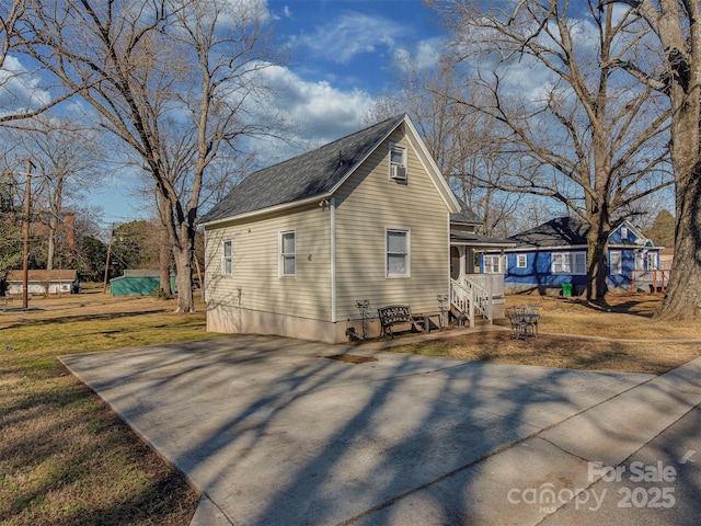 view of home's exterior featuring a porch and a yard