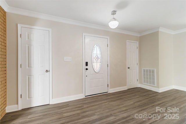 entryway with crown molding and dark hardwood / wood-style floors