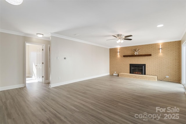 unfurnished living room with crown molding, dark hardwood / wood-style floors, a fireplace, and ceiling fan