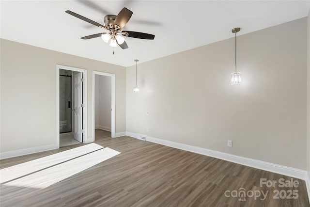 unfurnished bedroom with ensuite bathroom, ceiling fan, and dark hardwood / wood-style flooring