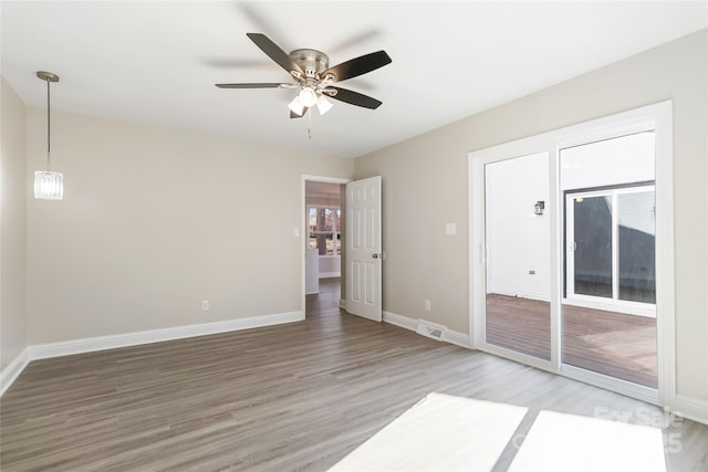 unfurnished room featuring hardwood / wood-style flooring and ceiling fan