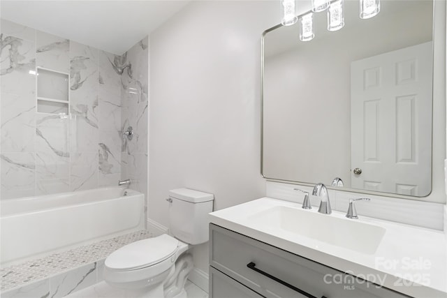 full bathroom with vanity, tiled shower / bath combo, and toilet